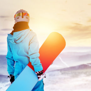 Snowboarderin Sonnenuntergang Schnee